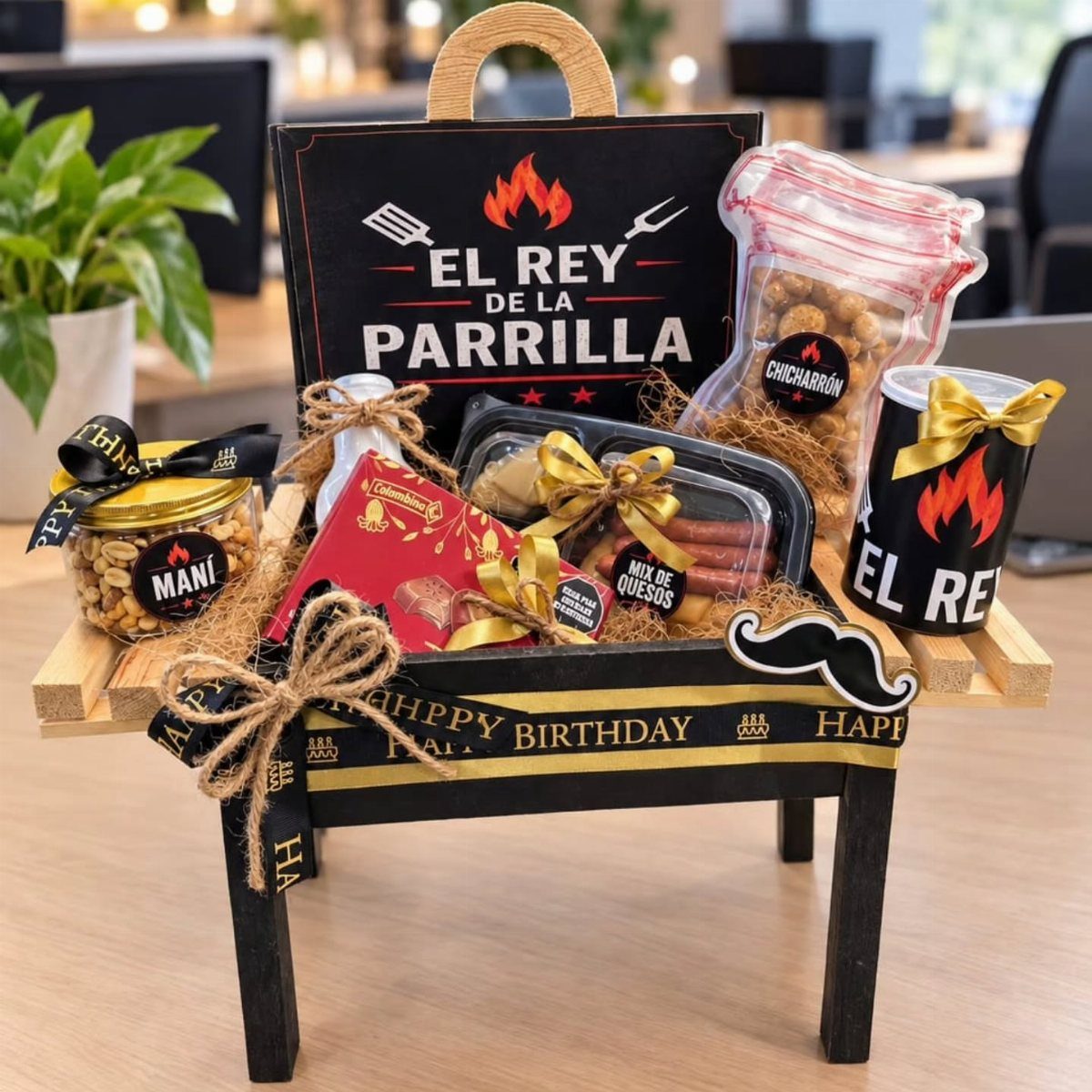 BBQ themed gift basket arranged on a miniature black grill with various snacks