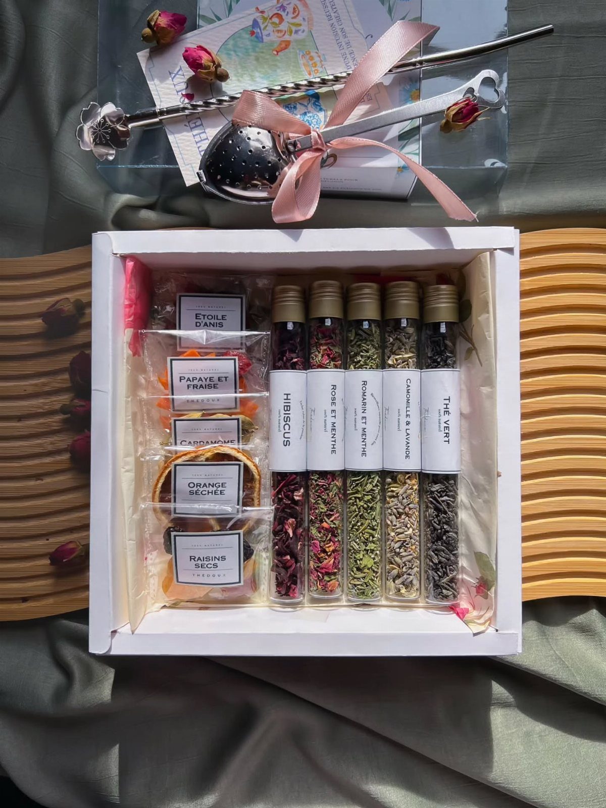 Tea gift set in a white box with glass tubes of loose leaf tea.