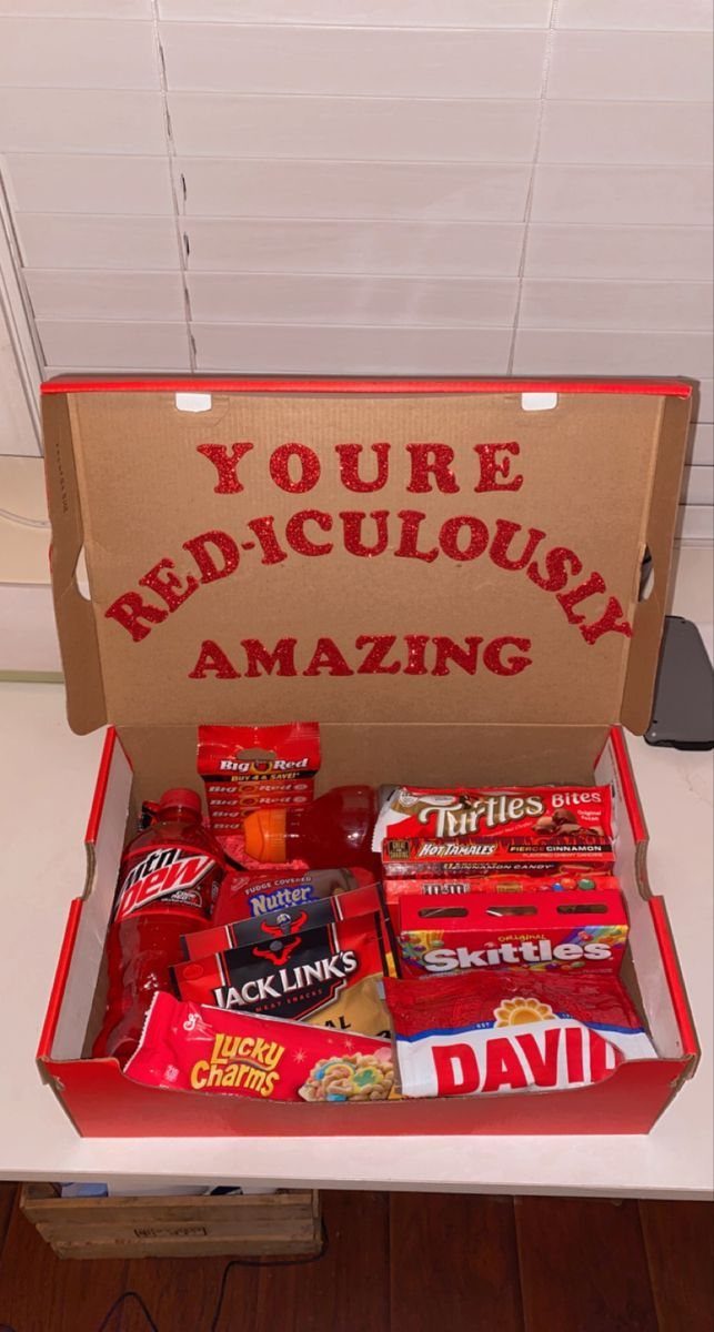 Red gift box filled with red snacks and a punny romantic message.