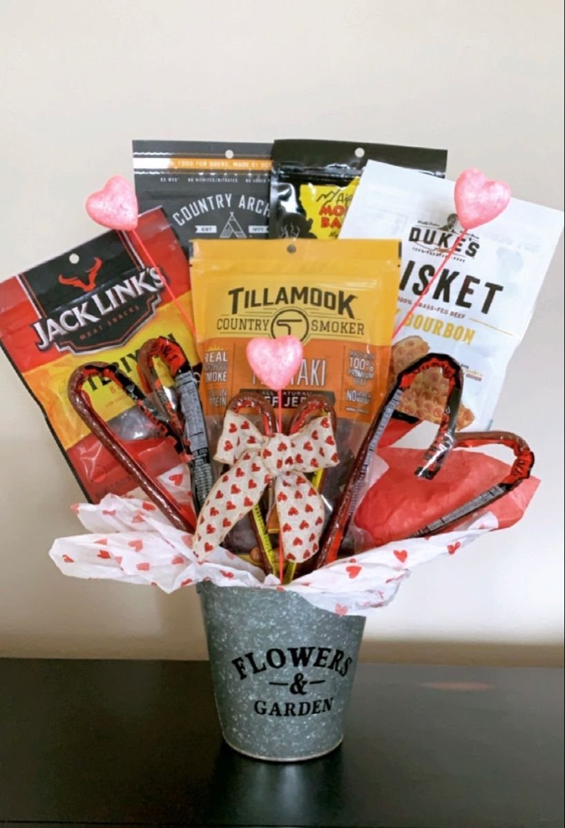 Snack gift basket in a metal bucket with heart decorations and jerky.