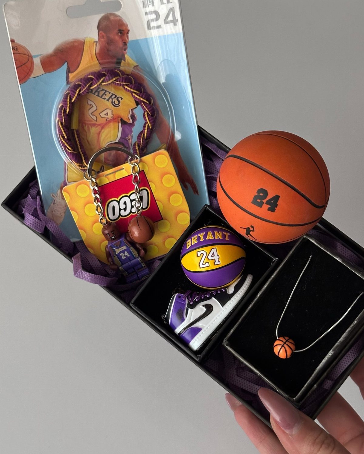 Basketball themed gift box with Kobe Bryant memorabilia, miniature ball, and jewelry.
