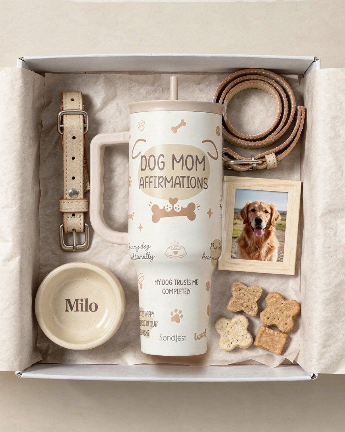 Dog themed gift box with tumbler, leash, dog treats, and a framed dog photo.